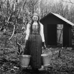 Yound Kven maid carrying water buckets to sauna.jpg